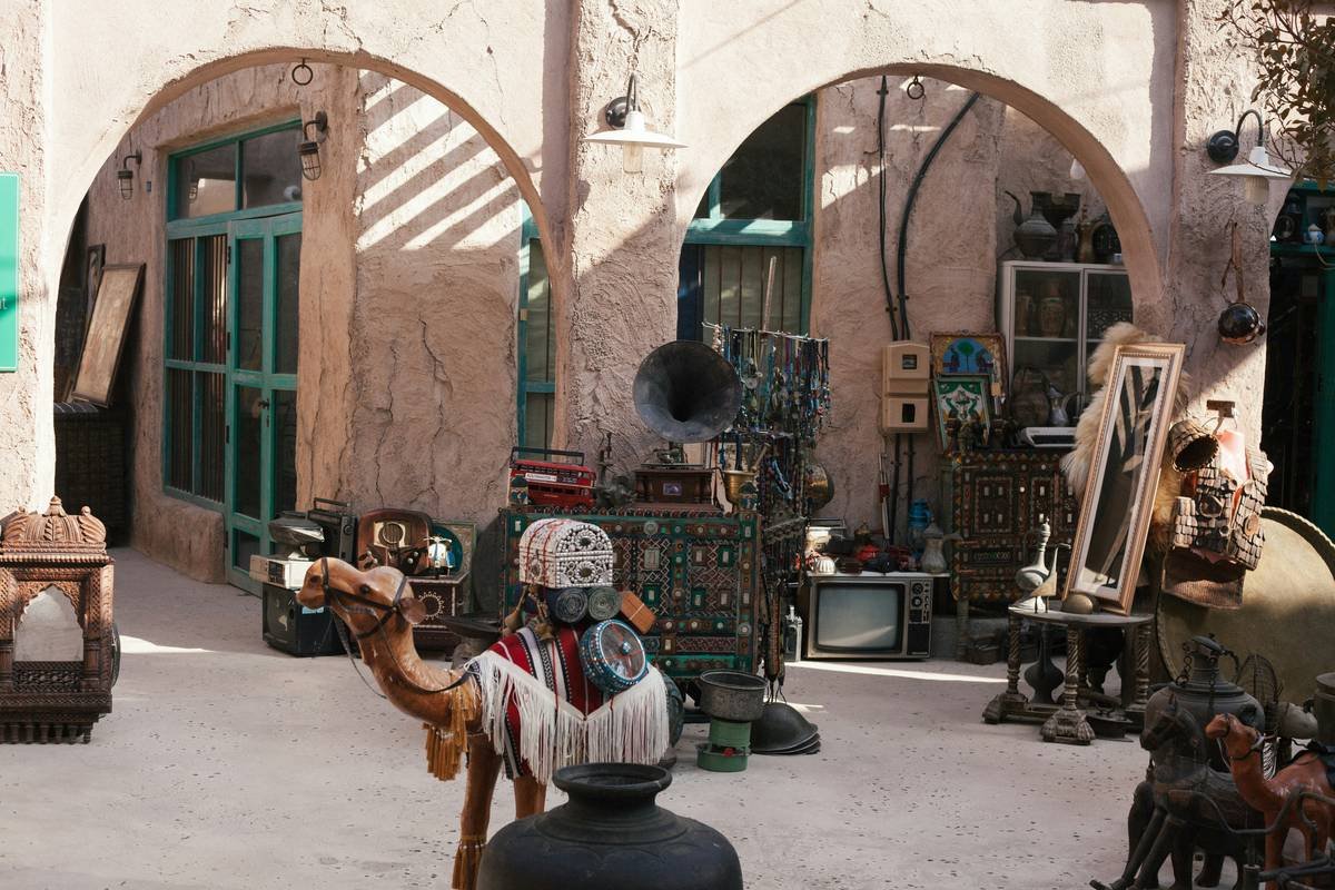 a street scene with a statue of a man on a camel