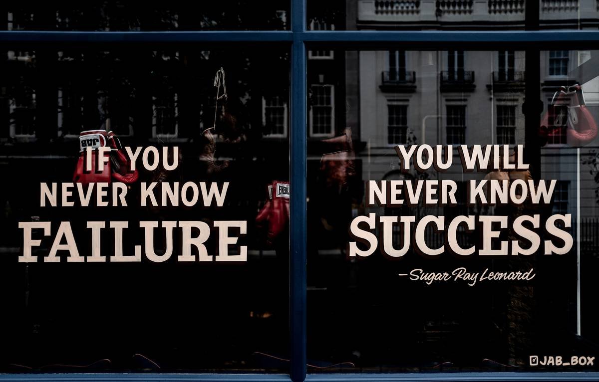 Motivational sign in the window of a boxing gym.