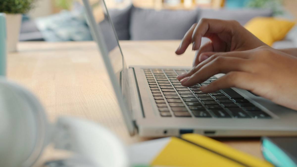 girl's hands typing using laptop at home at desk working at freelance project. Communication and modern technology concept.